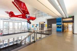 Raisbeck Aviation High School upper hall featuring plane hung from ceiling