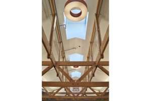  View up to ceiling with exposed wood trusses and clerestory windows at Vashon Island Library