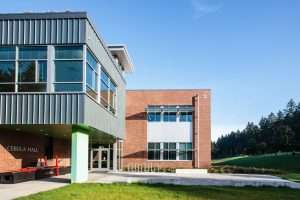 Saint Martin's University Cebula Hall entrance closeup featuring metal siding juxtapose to brick fascade