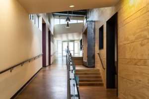 Bay Terrace Community Center interior hallway looking toward end of building featuring wood panel walls