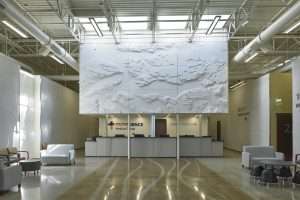 Providence Health Care West Olympia Clinic front reception with ceiling art feature of Puget Sound map in relief