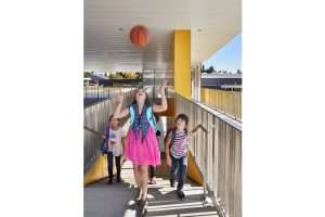 students coming up exterior stair with basketball at Northwood Elementary School