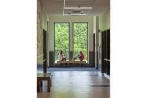 Two students looking out from a window seat
