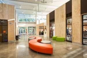 SAMi Environmental Learning Center interior lobby featuring colorful curved seating