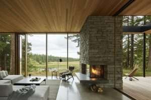 Whidbey Island Farmhouse living room with stone fireplace and meadow view