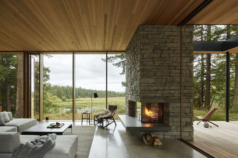 Whidbey Island Farmhouse Whidbey Island Farmhouse living room with stone fireplace and meadow view