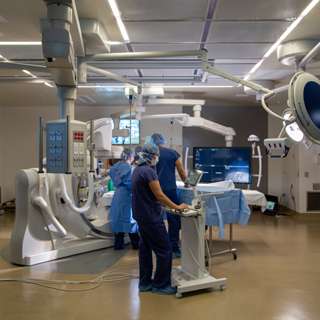 Harborview Medical Center Bi-Plane Operating Room with doctor and technicians and featuring 15,000 pounds of imaging equipment