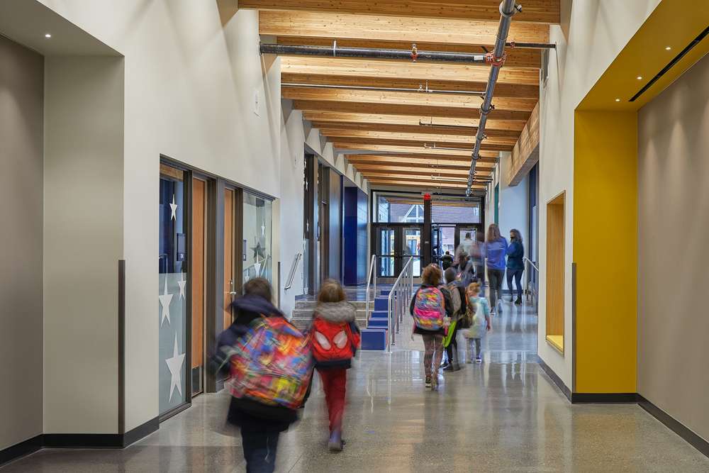 Students walking hallway featuring exposed timber ceiling at Birney Elementary School, Tacoma, WA