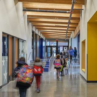 Students walking hallway featuring exposed timber ceiling at Birney Elementary School, Tacoma, WA
