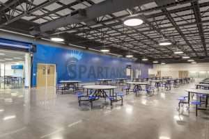 Hillsboro High School Renovation with exposed structural ceiling and Spartans wall mural, Hillsboro, OR
