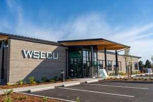 WSECU Building exterior front entry at day time, showing CLT entry canopy and brick exterior.