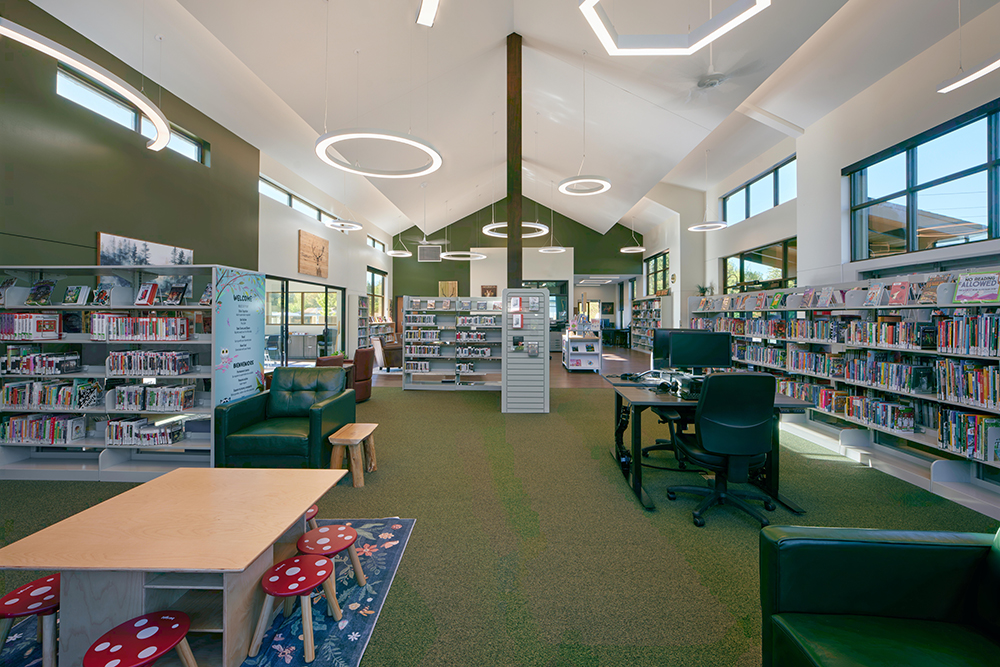 Mountain-View-Library-Interior The interior of a small library, containing green carpeted floors and walls, bright white ceilings and bookshelves around the sides.