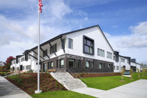 A white and brown school building has large lettering on its side that reads "Bryant Montessori School."