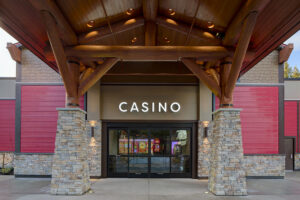 Round wood logs form the structure of a covered wooden entryway to the casino.