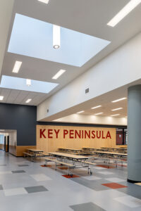 A cafeteria with "KEY PENINSULA" displayed in large red letters along the back wall.