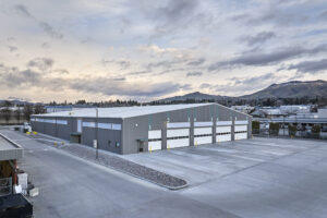 A large gray and white bus garage building.