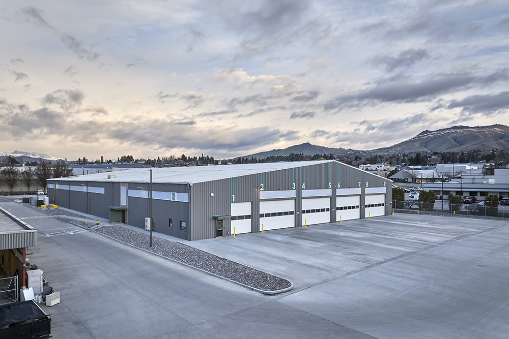 A large gray and white bus garage building.