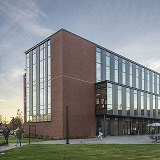 A large, rectangular, three-story brick building with tall windows.