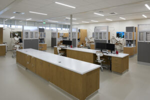 A college dental clinic with long work benches in the foreground.
