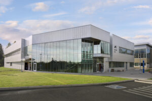 A silver-colored, angular building with tall windows.