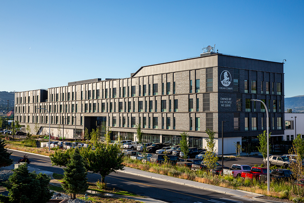 Chelan-PUD-Service-Center-Wide-Exterior A large, rectangular brown building with four stories against a blue sky.